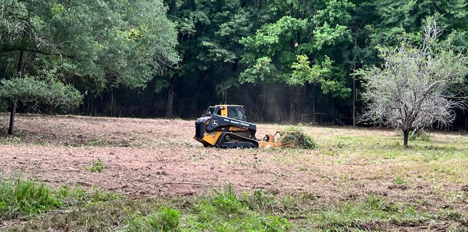 a machine performing land clearing 