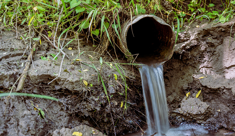 a drain with water coming out creating a drainage solution 